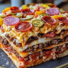 a stack of pizza on a plate with pepperoni, cheese and other toppings