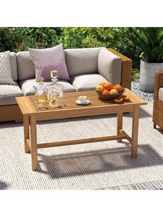 a wooden table sitting on top of a patio next to couches and tables with drinks