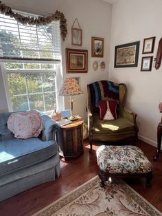 a living room filled with furniture and pictures on the wall