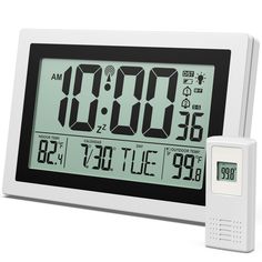 an alarm clock and thermometer on a white background