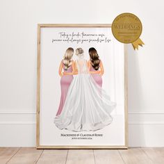 two women in wedding gowns are standing next to each other, with a gold medal around them