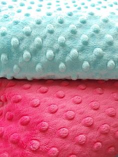 three different colored towels stacked on top of each other in the shape of polka dots