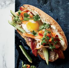 a sandwich with an egg and vegetables on it