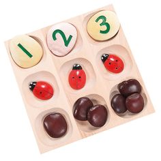 a wooden counting game with ladybugs and rocks