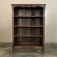 an old wooden bookcase sitting on the floor