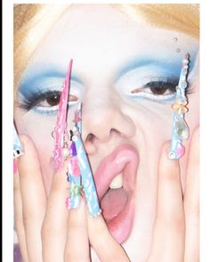 a close up of a person holding two toothbrushes in front of her face