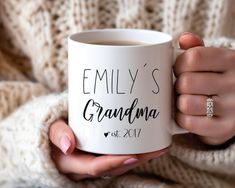 a woman holding a coffee mug with the words, family's grandma on it