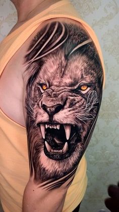 a man with a lion tattoo on his arm and chest, showing the face of a tiger