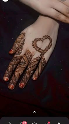 someones hand with henna tattoos on it and the words love written in arabic