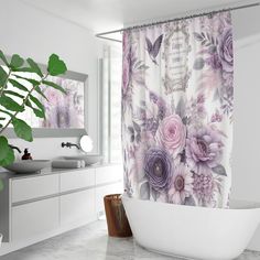 a bathroom with a tub, sink and shower curtain that has purple flowers on it