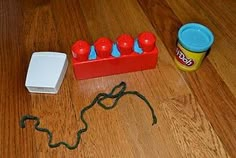 an unopened can of soda sits on the floor next to some play doughnuts