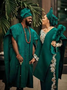 two people dressed in green standing next to each other