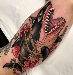 a man with a shark tattoo on his arm