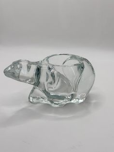 a clear glass animal figurine sitting on top of a table