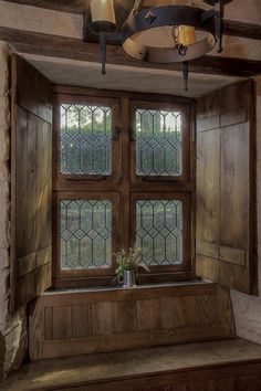 a wooden window sill sitting under a light fixture