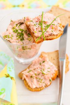 there is a plate with crackers and some food on it, next to a knife