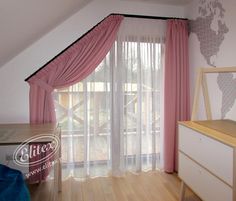 a bedroom with pink curtains and wooden floors