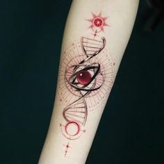 a tattoo on the arm of a person with a red ball and black spiral design