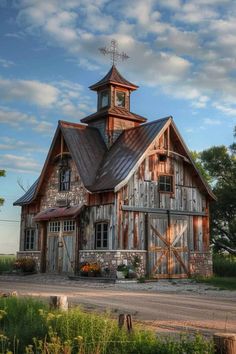 an old barn with a steeple on the top and a clock tower above it