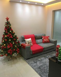 a living room with a christmas tree in the corner