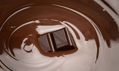 the chocolate is in the bowl with white liquid