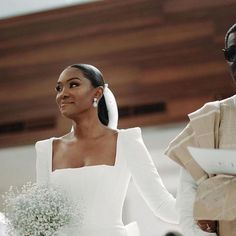 a bride and groom walking down the aisle