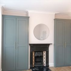 a living room filled with furniture and a mirror on top of a fireplace mantel