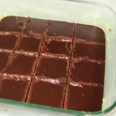 chocolate squares in a glass dish on a table