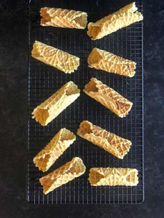 several pieces of pizza sitting on top of a cooling rack with text overlay that reads, how to make homemade pizza cannoi shells