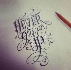 the words never give up written in cursive writing on a piece of paper