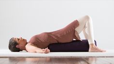 a man laying on the floor with his head down and arms behind his back as if he is doing yoga