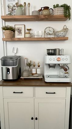 there is a coffee maker on top of the counter in this small kitchen with shelves above it