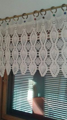 the curtain is made with white crochet