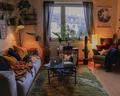 a living room filled with furniture and lots of plants on the windows sills