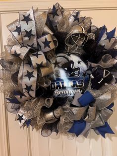 a football wreath with the word dallas written on it in silver, black and blue