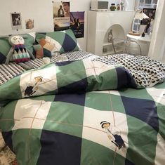 a green and white checkered comforter set on a bed