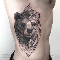 a bear tattoo on the side of a man's stomach