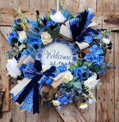 a welcome wreath with blue and white flowers