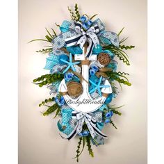 a blue and white wreath with an anchor, seashells, and starfish