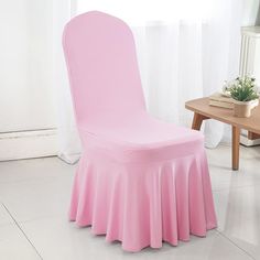 a pink chair covered with a table cloth