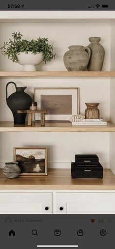 a shelf with vases and other items on it