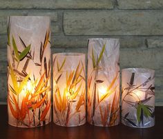 three lit candles sitting next to each other on a table