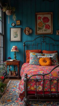 a bed room with a neatly made bed and lots of pictures on the wall above it