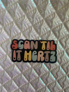 a sticker with the words scan't tell it merz written in multicolored letters