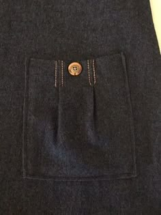 there is a pocket on the back of a skirt that has buttons in it and two pockets at the bottom