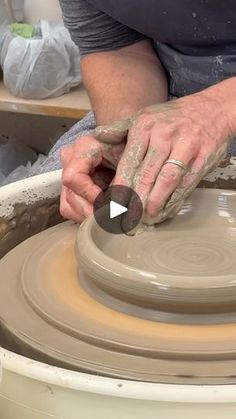 a person is making a vase on a potter's wheel