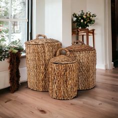 three woven baskets sitting on top of a wooden floor