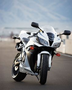 a white and black motorcycle parked on the street