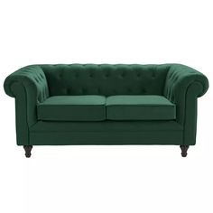 a green couch sitting on top of a white floor