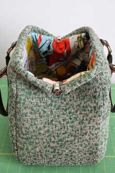 a purse sitting on top of a green cutting board